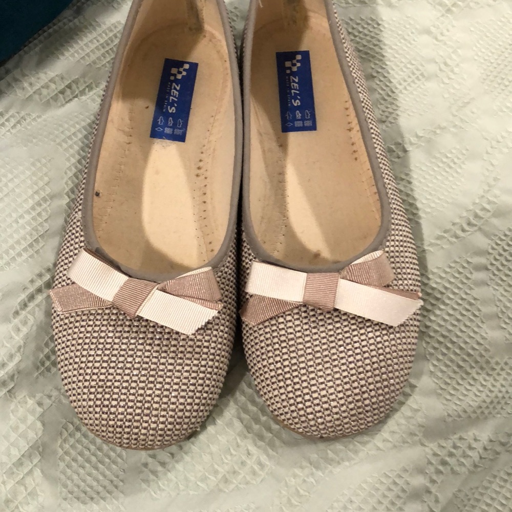 Silver flats with white bows.